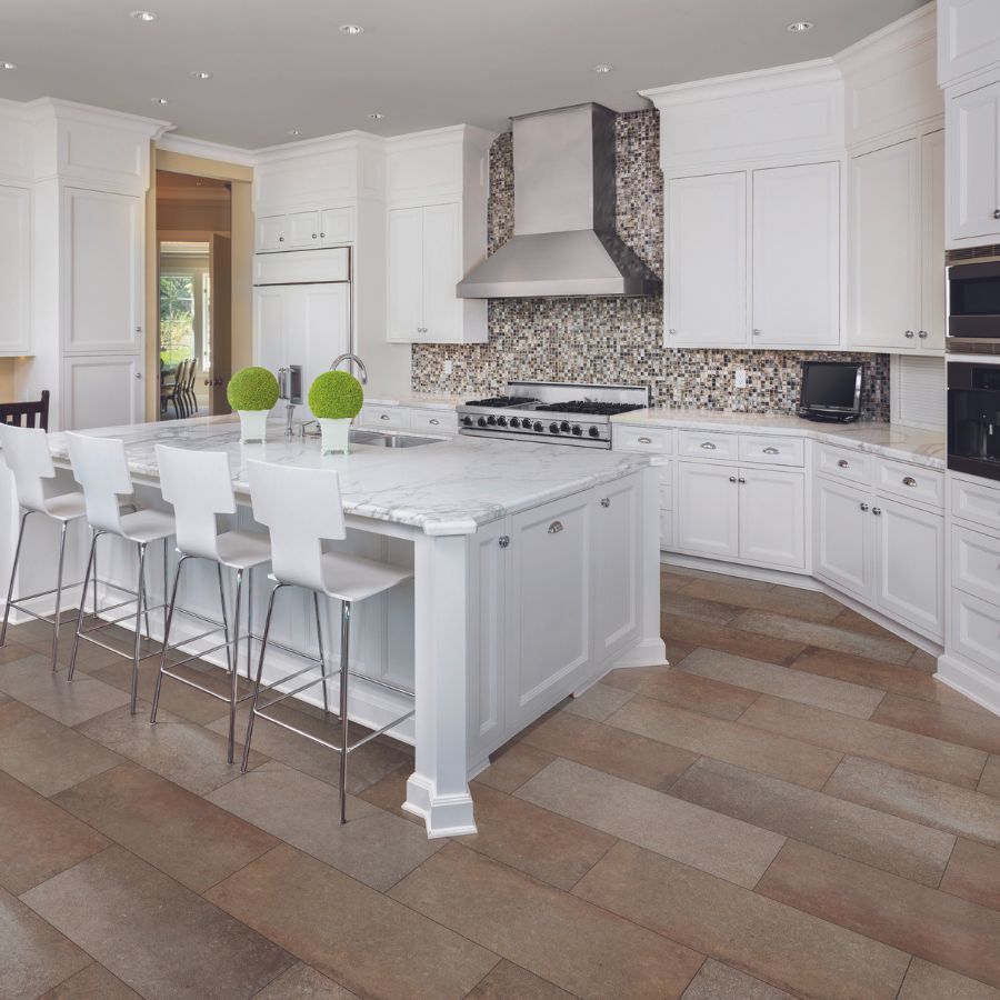 countertops in a bright spacious kitchen with island and hood